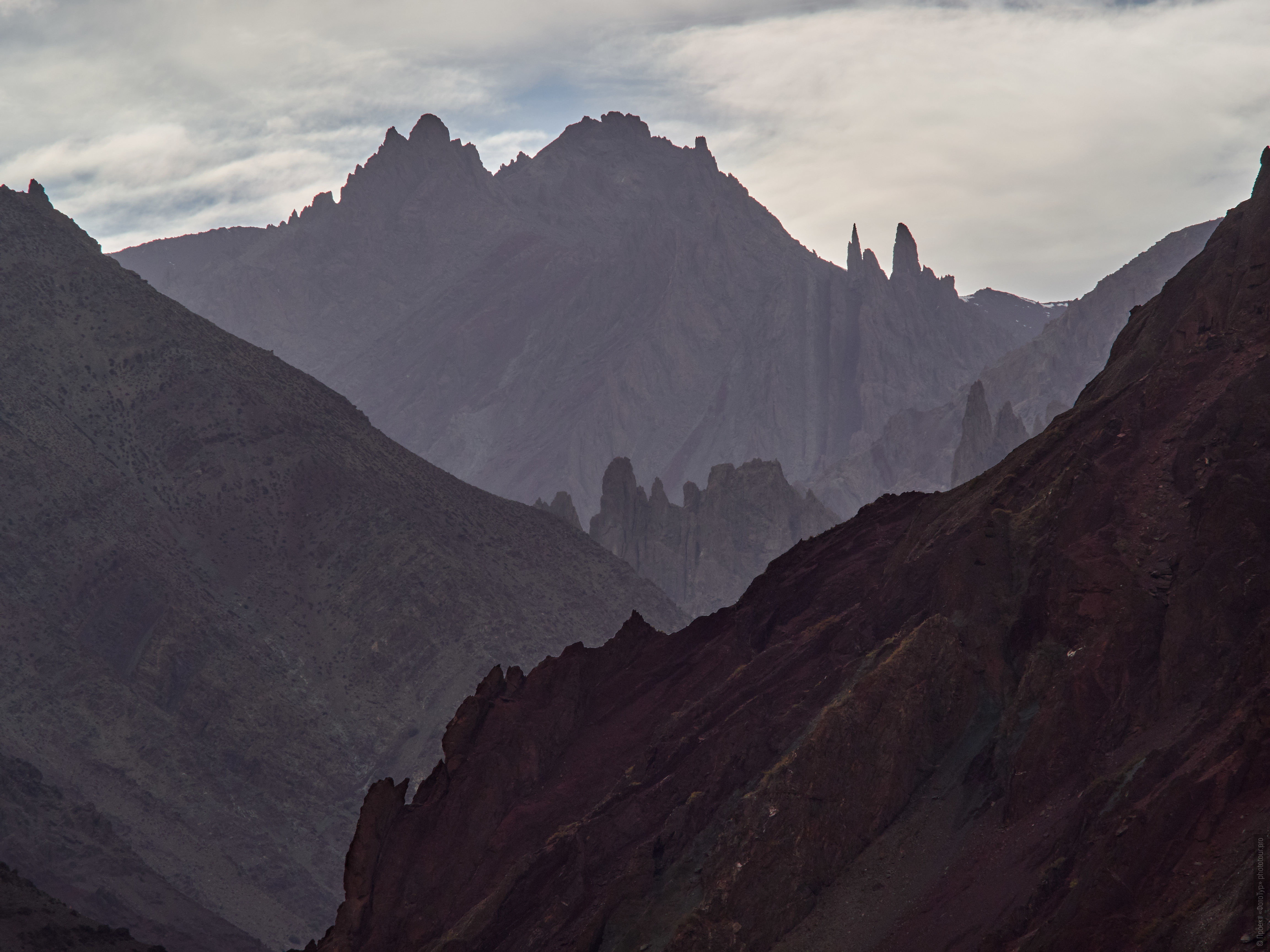 Mountain ranges of Burgundy Gorge. Tour Tibet Lakeside Advertising: Alpine lakes, geyser valley, Lamayuru, Colored Mountains, 01 - 10.09. 2023 year.